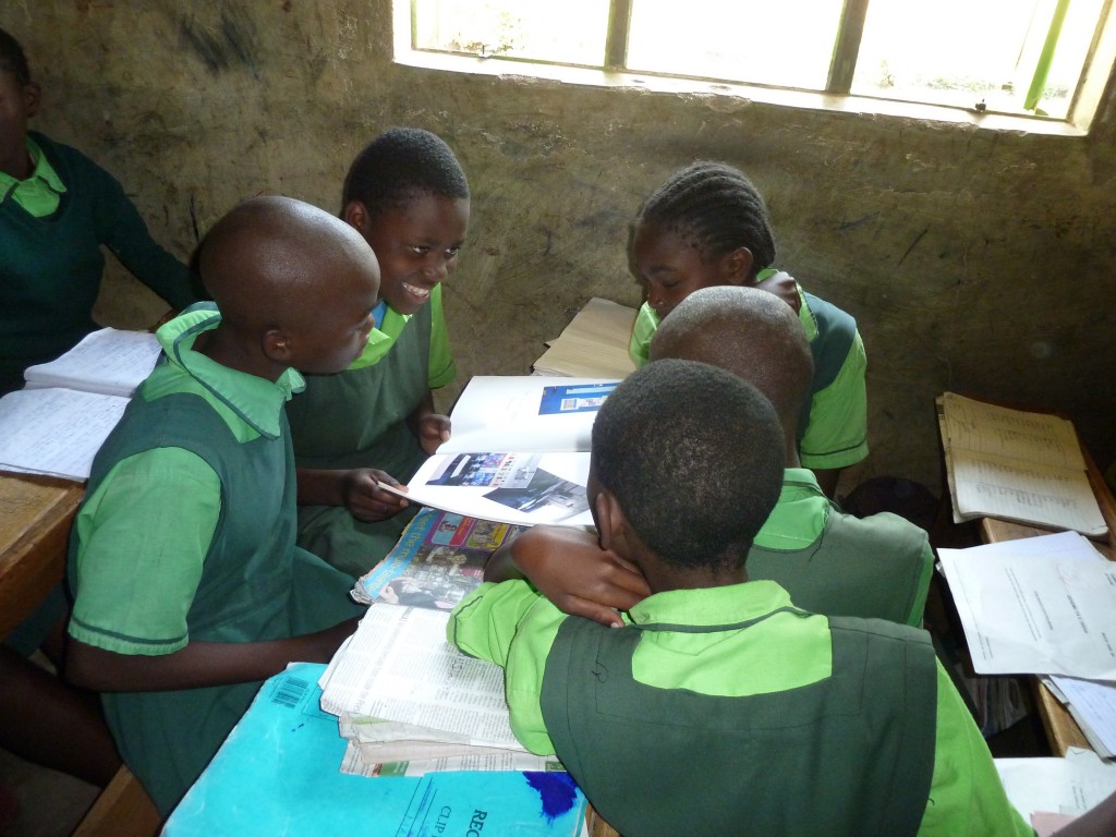 Children looking at scrapbooks